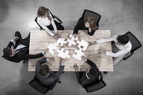 Teamwork of partners. Concept of integration and startup with puzzle pieces