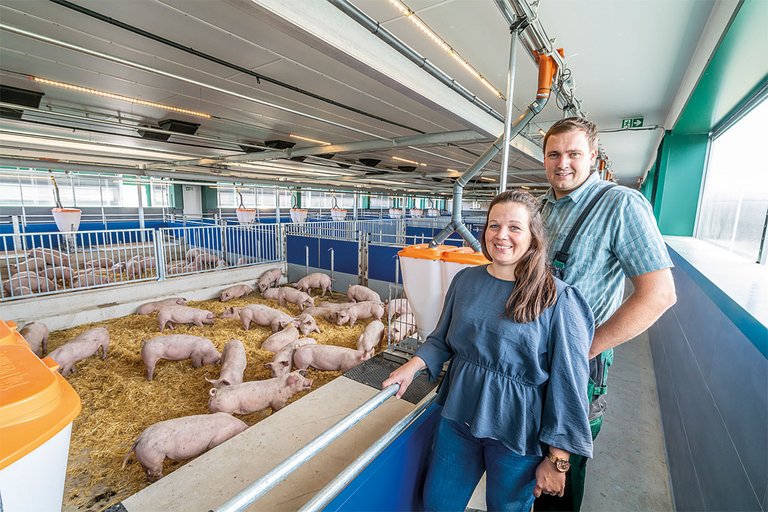 Couple in a pig finishing house