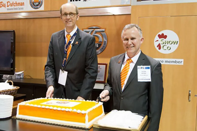 Celebrating 75 years of successful poultry systems with a huge anniversary cake.